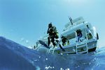 Diver jumping in the water from a day boat in a reef close to El Gouna, Egypt