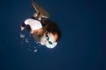 Female free diver diving out